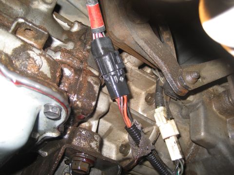 1989 Ford Bronco - Close-up view of an engine wiring harness connector with visible wires and connectors.