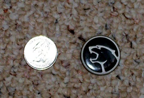 2003 Ford Expedition - A cougar emblem is shown next to a U.S. quarter for size comparison.
