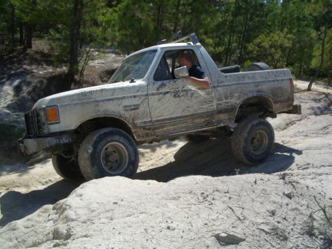 1979 Ford Bronco - This lifted 1980s Ford Bronco is navigating a challenging off-road course.
