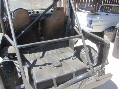 1987 Suzuki Samurai - Interior view of a 1987 Suzuki Samurai with a roll cage and large fuel tank installed.