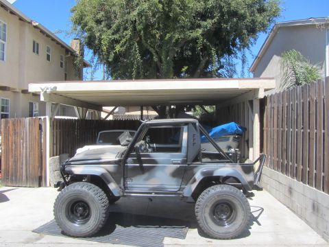 1987 Suzuki Samurai - Modified 1987 Suzuki Samurai with custom roll cage and camouflage paint job.