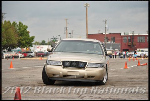 2000 Mercury Grand Marquis - Gold 2000 Mercury Grand Marquis navigates a course marked by orange cones.