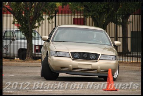 2000 Mercury Grand Marquis - A tan sedan navigates a course, its front end angled towards the camera.