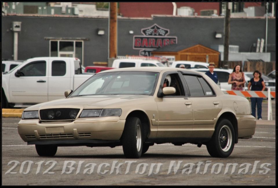 Tan 2000 Mercury Grand Marquis sedan, 3q front view