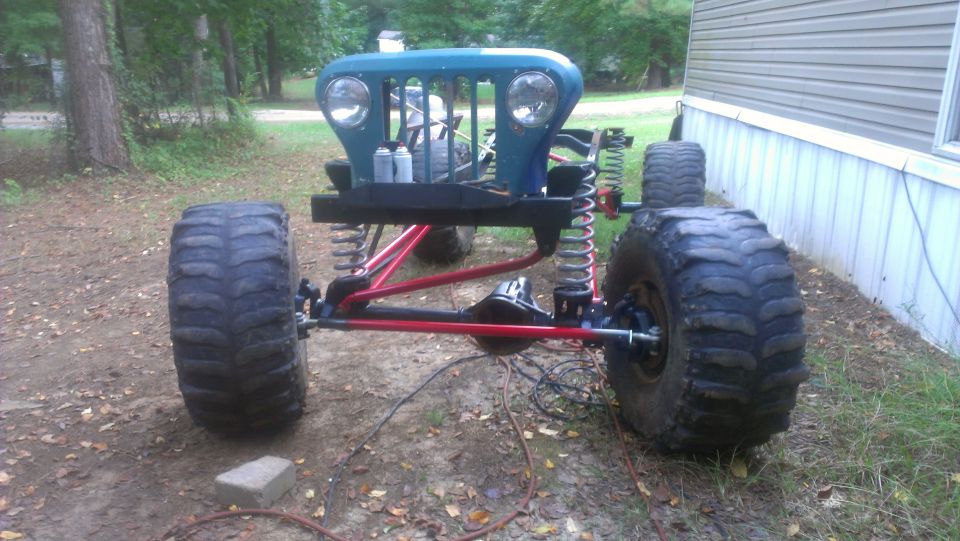 Off-road vehicle chassis with large tires and blue grille