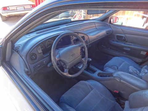 1993 Ford Taurus - Interior view of a 1993 Ford Taurus, with another vehicle visible through the windshield.