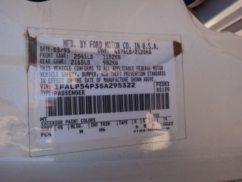 1993 Ford Taurus - A vehicle's identification sticker shows manufacturing details, including the date and VIN.
