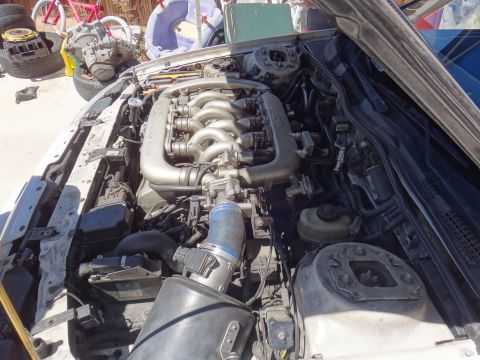 1993 Ford Taurus - The engine bay of a car is shown with the hood open, revealing the V6 engine and associated components.