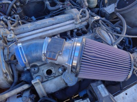 1993 Ford Taurus - The engine bay features an aftermarket air intake system with a purple filter and a visible mass air flow sensor.