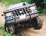 1990 Ford Bronco - A gray SUV navigates an off-road trail, its grille and tires prominent in this three-quarter front view.