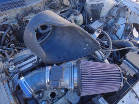 1993 Ford Taurus - Aftermarket air intake system installed in a vehicle's engine bay.