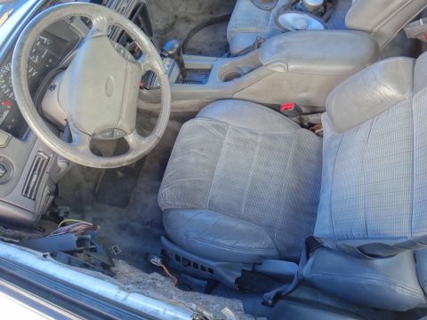 1993 Ford Taurus - The interior of a 1993 Ford Taurus, the driver's side controls and passenger seating.