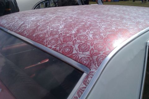 1991 Ford LTD Crown Victoria - The roof of a car is covered in a patterned fabric with roses and leaves.