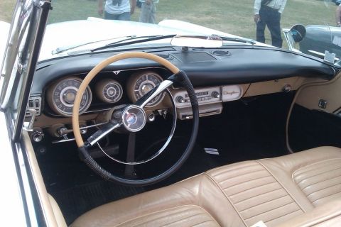 1991 Ford LTD Crown Victoria - Classic car interior with a large steering wheel and tan upholstery. The dashboard features multiple gauges and a radio.
