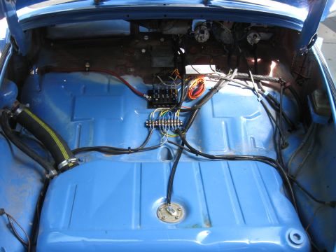 1970 Volkswagen Beetle - Custom wiring and fuel tank installation visible in the blue interior of a vehicle.