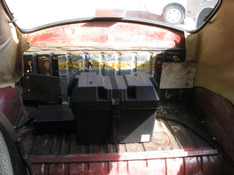 1970 Volkswagen Beetle - The rear interior of a vehicle shows a battery box and an electronics box.