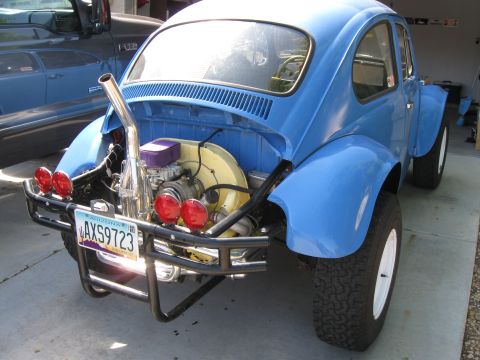 1970 Volkswagen Beetle - This blue Baja Bug features an exposed engine and a prominent custom exhaust system, with off-road tires and a roll cage.