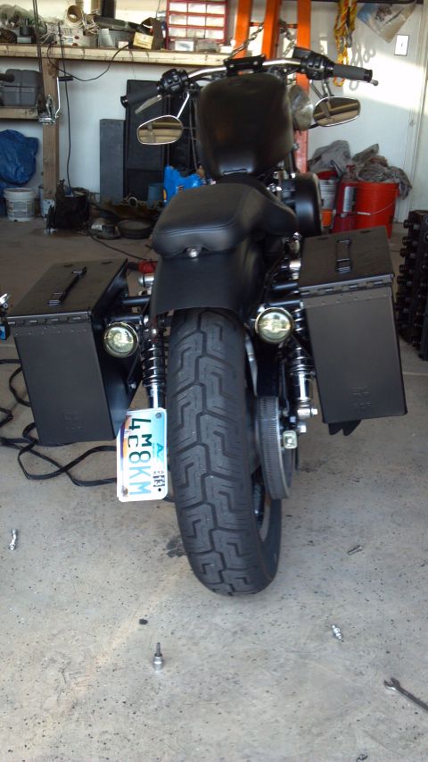 2002 Harley-Davidson XL Sportster - Rear view of a black motorcycle parked indoors.