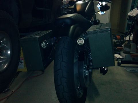 2002 Harley-Davidson XL Sportster - This motorcycle features black saddlebags and round aftermarket lights mounted on the rear fender supports.