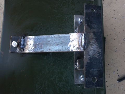 2002 Harley-Davidson XL Sportster - A custom metal bracket is shown, attached with bolts and welds to a textured surface.