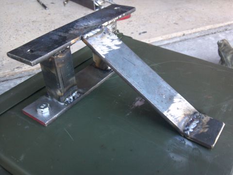 2002 Harley-Davidson XL Sportster - A custom metal bracket, likely for a motorcycle, is shown from a close-up angle.