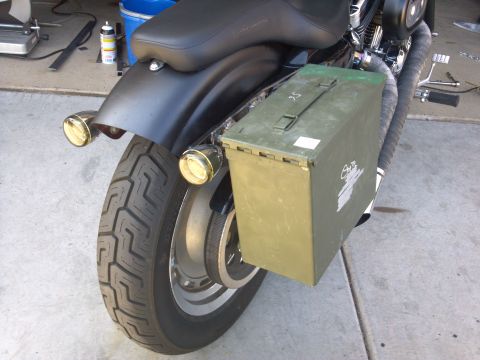 2002 Harley-Davidson XL Sportster - Rear view of a motorcycle an olive drab ammo can mounted as a saddlebag, with dual chrome tail lights visible.