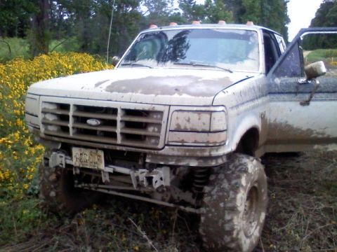 1993 Ford F-150 - This lifted pickup truck appears to be from the early 1990s, not a 1993 model.