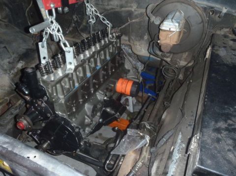 1978 Ford Bronco - Engine installation in progress, showing the engine block, valve covers, and oil filter.