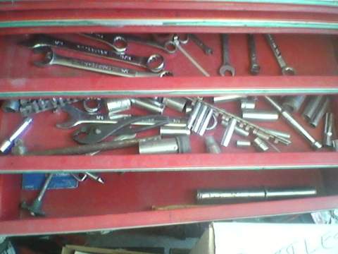 1996 Ford F-150 - A red toolbox is filled with various wrenches and sockets, organized across its drawers.