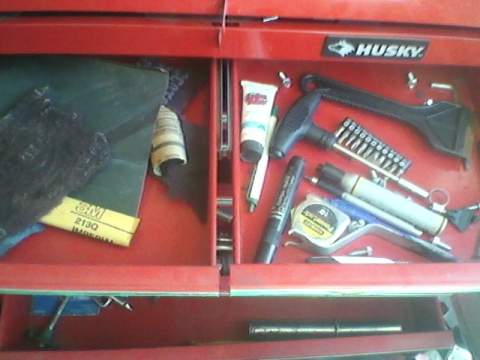 1996 Ford F-150 - A red Husky tool drawer is filled with various automotive maintenance supplies and repair supplies.