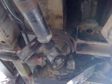 1987 Suzuki Samurai - Underside view of vehicle drivetrain components, showing the driveshaft and transfer case.
