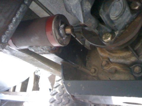 1987 Suzuki Samurai - Undercarriage view of a vehicle part, possibly a shock absorber or damper, with visible welding.