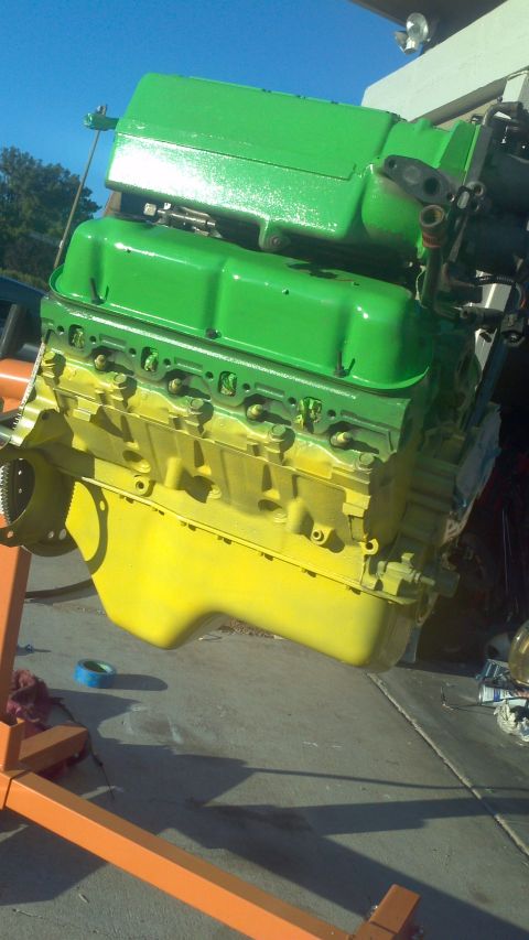 1987 Ford Bronco - This engine, painted in green and yellow, is currently on an engine stand.