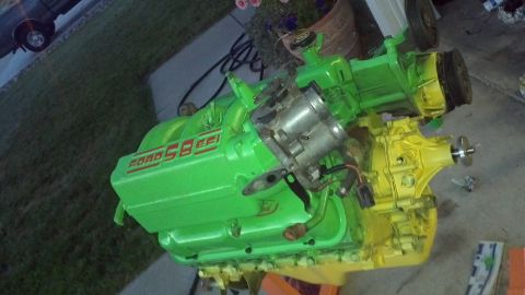1987 Ford Bronco - A Ford 5.8 EFI engine painted bright green and yellow is shown.