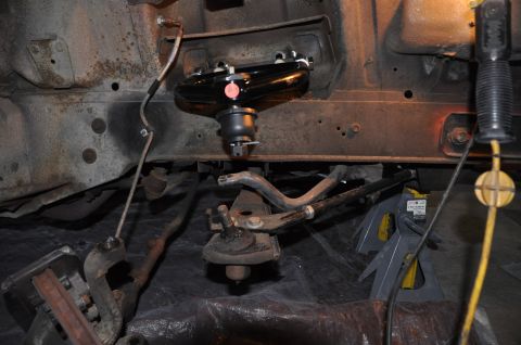 1971 Ford Mustang - Close-up view of a vehicle's front suspension assembly, focusing on the upper control arm and ball joint.