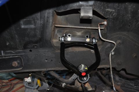 1971 Ford Mustang - Close-up of a vehicle's front suspension component, likely an upper control arm.