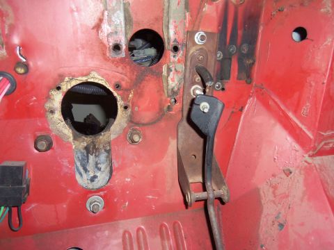 1968 Ford Bronco - Close-up view of the interior firewall, showing the clutch pedal assembly and openings for wiring harnesses.