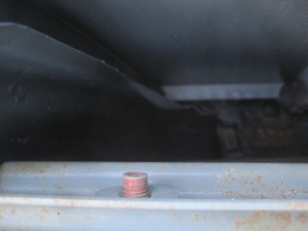 1993 Ford Bronco - Close-up of a red cap on a vehicle chassis component.