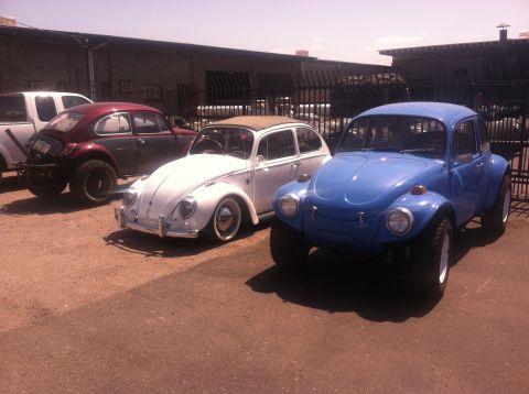 1970 Volkswagen Beetle - Three modified Volkswagen Beetles are parked outdoors, including a blue Baja Bug in the foreground.