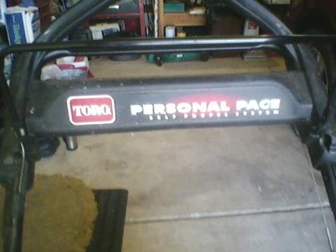 1996 Ford F-150 - Close-up of the Toro Personal Pace self-propelled system label on a lawnmower.