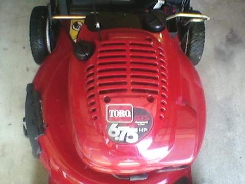 1996 Ford F-150 - A red Toro lawnmower is shown from a top-down perspective, highlighting its engine cover and branding.