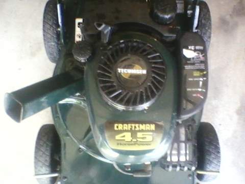 1996 Ford F-150 - Close-up view of a green Craftsman lawn mower, highlighting its 4.5 horsepower engine and deck.