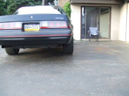 1996 Ford Bronco - Rear view of a black coupe, possibly a Ford Thunderbird Turbo Coupe, with a yellow license plate.