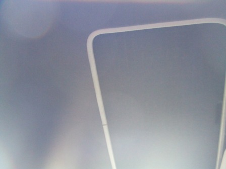 1996 Ford Bronco - Interior view of a vehicle's gray ceiling with white trim and a website logo.