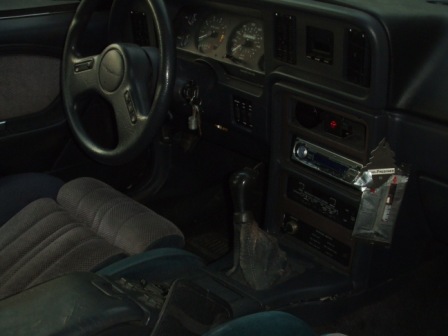 1996 Ford Bronco - Interior view of a car's dashboard, steering wheel, and seats.