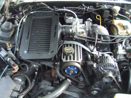 1996 Ford Bronco - Close-up view of a vehicle's engine bay, showing various components and wiring.