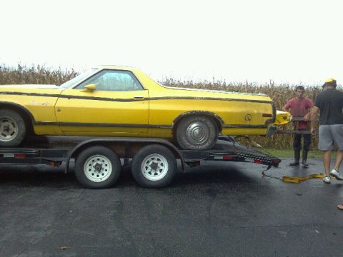 1974 Ford Ranchero - Yellow 1974 Ford Ranchero being loaded onto a trailer with two people assisting.
