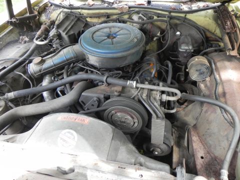 1974 Ford Ranchero - Close-up view of a car's engine bay, showing various mechanical components and wiring.