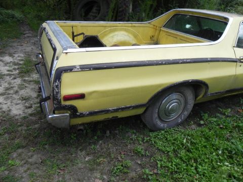 1974 Ford Ranchero - Rear view of a yellow Ford Ranchero pickup truck parked outdoors.