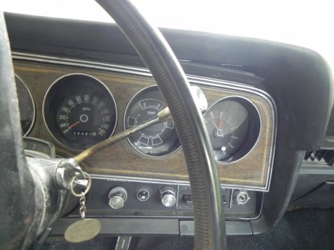 1974 Ford Ranchero - Dashboard gauges of a 1974 Ford Ranchero, including speedometer, temperature, and clock.